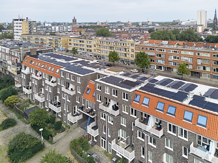 Luchtfoto van een appartementencomplex met allemaal zonnepanelen op het dak